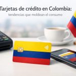 Imagen de una tarjeta bancaria con los colores de Colombia colocada sobre una superficie junto a un datáfono, un teléfono móvil mostrando una tarjeta digital y una taza de café. Al fondo, una pequeña bandera colombiana refuerza el contexto local. La escena representa el uso moderno de tarjetas de crédito en Colombia, destacando la digitalización de pagos, la integración con dispositivos móviles y las nuevas formas de consumo financiero en el país.